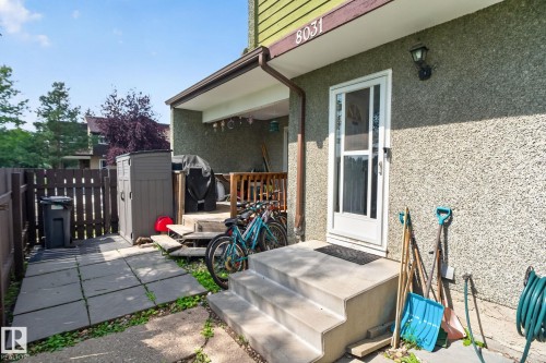 Exterior featuring textured stucco siding and a covered entry - 8031 27 Avenue Nw, Edmonton, AB - Outdoor With Deck Patio Veranda With Exterior