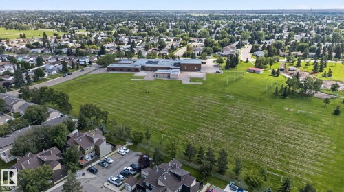 Expansive green space and a multi-building structure within a residential neighborhood - 8031 27 Avenue Nw, Edmonton, AB - Outdoor With View