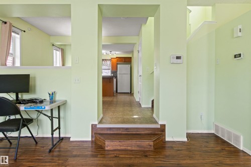 Wood-finish flooring, half-wall partition, and stepped entry - 9118 Scott Crescent Nw, Edmonton, AB - Indoor