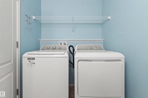 Laundry area featuring a wire shelf and wall-mounted hooks - 9118 Scott Crescent Nw, Edmonton, AB - Indoor Photo Showing Laundry Room