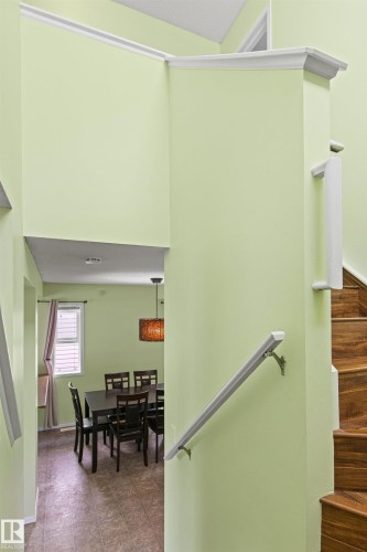 Recessed lighting, wood-finish stair treads, and a semi-flush pendant light fixture - 9118 Scott Crescent Nw, Edmonton, AB - Indoor Photo Showing Other Room