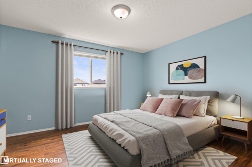 Wood-finish flooring, light blue wall paint, and a window with roller shades - 9118 Scott Crescent Nw, Edmonton, AB - Indoor Photo Showing Bedroom