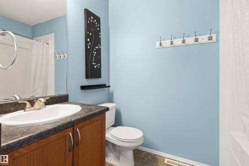 Vanity with a laminate countertop and an integrated sink - 9118 Scott Crescent Nw, Edmonton, AB - Indoor Photo Showing Bathroom