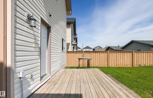 Wood deck, vinyl siding, privacy fencing, exterior lighting, green lawn - 9118 Scott Crescent Nw, Edmonton, AB - Outdoor With Deck Patio Veranda With Exterior