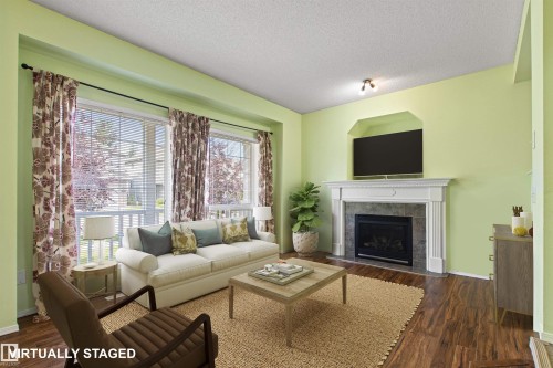 Living area featuring a fireplace with a mantel, tile surround, and an integrated media niche - 9118 Scott Crescent Nw, Edmonton, AB - Indoor Photo Showing Living Room With Fireplace