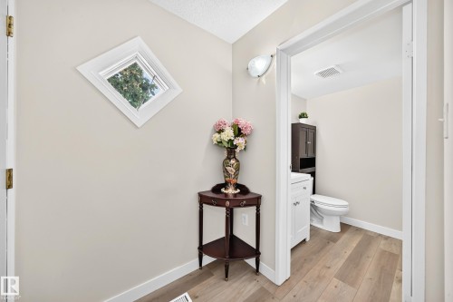 Secondary room featuring light wood-finish flooring, a white vanity with an undermount sink, and a toilet - #22 3812 20 Av Nw, Edmonton, AB - Indoor Photo Showing Other Room