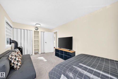 Wall-to-wall carpeting with light-colored walls and a flat ceiling - #22 3812 20 Av Nw, Edmonton, AB - Indoor Photo Showing Bedroom