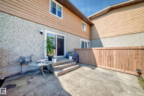 Concrete patio with steps leading to a sliding glass door - #22 3812 20 Av Nw, Edmonton, AB - Outdoor With Deck Patio Veranda