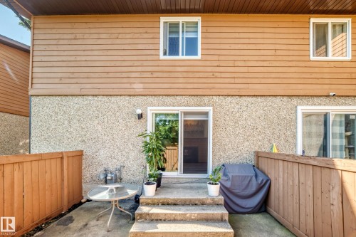 Private patio space featuring a concrete surface, wood fencing, and a concrete staircase - #22 3812 20 Av Nw, Edmonton, AB - Outdoor With Deck Patio Veranda With Exterior