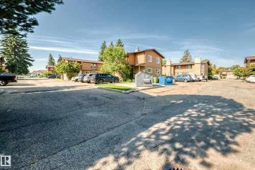 Paved parking area with designated vehicle spaces - #22 3812 20 Av Nw, Edmonton, AB - Outdoor