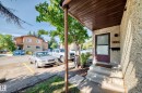 Concrete steps with a textured exterior, covered entry, and a contrasting front door - #22 3812 20 Av Nw, Edmonton, AB  - Outdoor With Exterior 