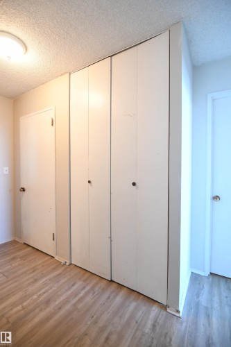 The hallway closet extends floor to ceiling, and provides great storage.  The door next to the closet accesses a large, in unit storage room for all your treasures.  An additional storage room is just down the hallway, perfect for bulky or seasonal items - #1305 13910 Stony Plain Rd Nw, Edmonton, AB - Indoor Photo Showing Other Room
