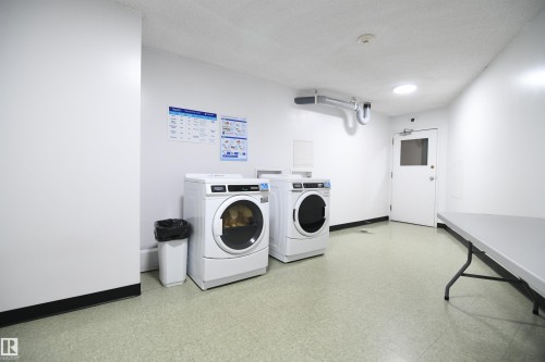 Each floor in the building is equipped with a large, bright laundry room.  Convenient trash chutes, and multiple elevators provide maximum convenience - #1305 13910 Stony Plain Rd Nw, Edmonton, AB - Indoor Photo Showing Laundry Room
