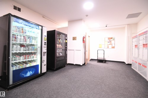 Similar to what you may find in some boutique hotels, vending machines have even been installed for the convenience of the residents - #1305 13910 Stony Plain Rd Nw, Edmonton, AB - Indoor Photo Showing Other Room