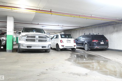 The secured, heated parkade is bright and open, with wide drive aisles, and easy driving access - #1305 13910 Stony Plain Rd Nw, Edmonton, AB - Indoor Photo Showing Garage