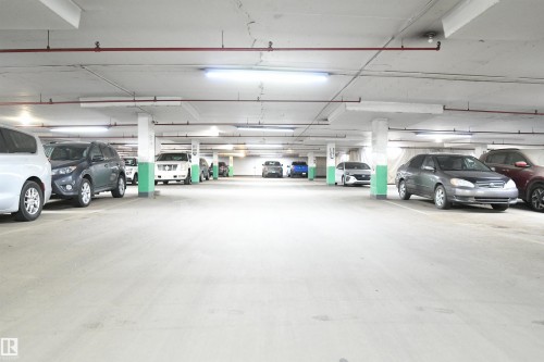 The secured, heated parkade is bright and open, with wide drive aisles, and easy driving access - #1305 13910 Stony Plain Rd Nw, Edmonton, AB - Indoor Photo Showing Garage
