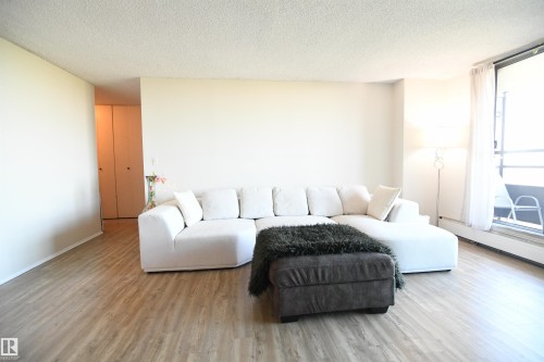 The open living room layout lends itself well to several furniture placement options, and whether you prefer a modern, contemporary, or a traditional vibe, this unit easily adapts to serve - #1305 13910 Stony Plain Rd Nw, Edmonton, AB - Indoor Photo Showing Living Room