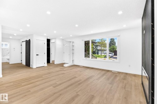 Expansive open-concept living area featuring wood-finish flooring, recessed lighting, and a large picture window - 5 Peace River Drive, Devon, AB - Indoor Photo Showing Living Room