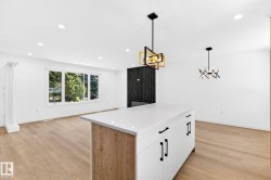 Kitchen island featuring a white countertop and wood-finish paneling - 