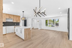 Open concept living area featuring wood-finish flooring, recessed lighting, and a contemporary linear chandelier - 