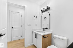 White vanity with wood-finish paneling and integrated sink - 