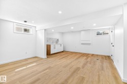 Recessed lighting illuminates the wood-finish flooring - 