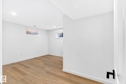 Wood-finish flooring, recessed lighting, white walls, and white trim - 5 Peace River Drive, Devon, AB - Indoor Photo Showing Other Room