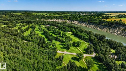 Expansive golf course setting featuring manicured fairways and mature trees - 5 Peace River Drive, Devon, AB - Outdoor With View