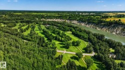Expansive golf course setting featuring manicured fairways and mature trees - 