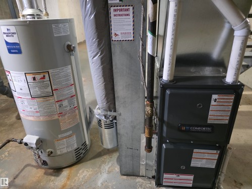 Water heater and furnace with exposed utility piping - 1907 145A Avenue Nw, Edmonton, AB - Indoor Photo Showing Basement