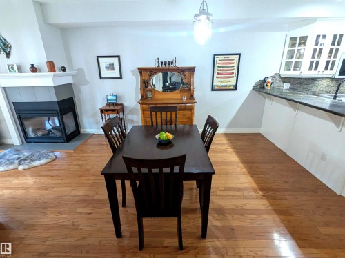 Lots of space for large family gatherings - #302 9811 96A St Nw, Edmonton, AB - Indoor Photo Showing Dining Room With Fireplace