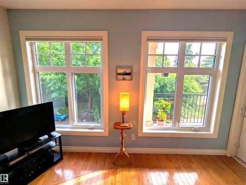 Great size living room with large windows, hardwood flooring and fresh paint - #302 9811 96A St Nw, Edmonton, AB - Indoor Photo Showing Other Room