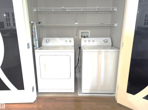 the laundry room is located just off the primary suite - #302 9811 96A St Nw, Edmonton, AB - Indoor Photo Showing Laundry Room