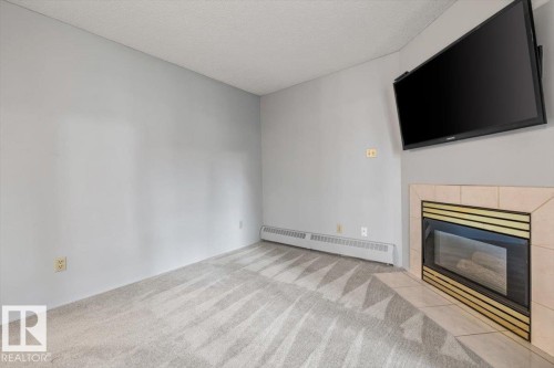#202 8503 108 St Nw, Edmonton, AB - Indoor Photo Showing Living Room With Fireplace