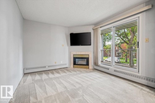 #202 8503 108 St Nw, Edmonton, AB - Indoor Photo Showing Living Room With Fireplace
