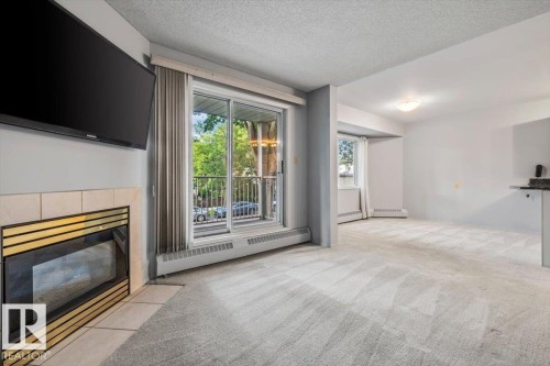 #202 8503 108 St Nw, Edmonton, AB - Indoor Photo Showing Living Room With Fireplace