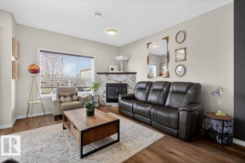 #76 3010 33 Av Nw, Edmonton, AB - Indoor Photo Showing Living Room With Fireplace