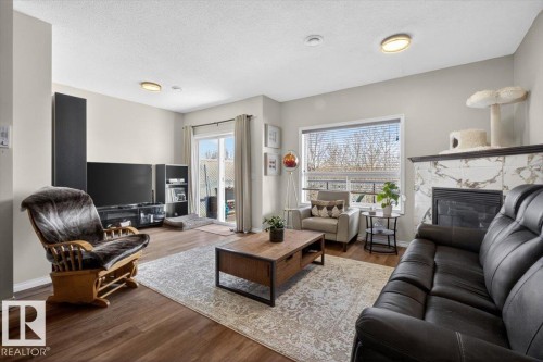 #76 3010 33 Av Nw, Edmonton, AB - Indoor Photo Showing Living Room With Fireplace