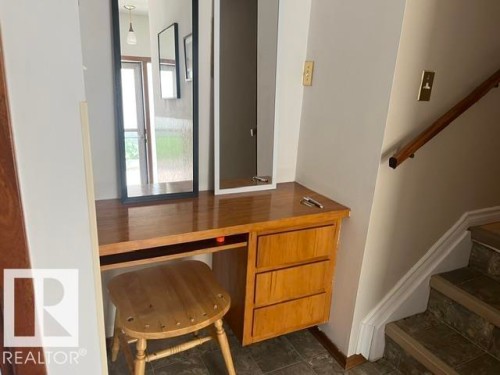 Built-in wood-finish desk with three drawers and polished top - 5213 50 Avenue, Vegreville, AB - Indoor Photo Showing Other Room