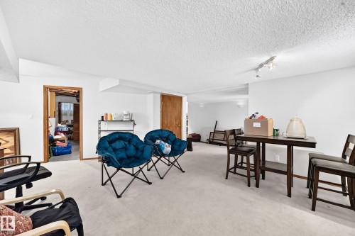 Carpeted flooring throughout, white painted walls, natural wood door frames, and track lighting fixture - 6 Atkinson Place, St. Albert, AB - Indoor
