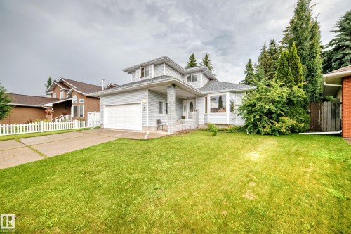 Two-story residence featuring light-colored siding, an attached garage, and a concrete driveway - 6 Atkinson Place, St. Albert, AB - Outdoor