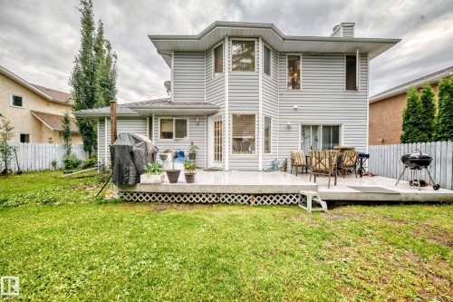 Siding exterior with multiple windows, a rear deck, and a sliding glass door - 6 Atkinson Place, St. Albert, AB - Outdoor With Deck Patio Veranda