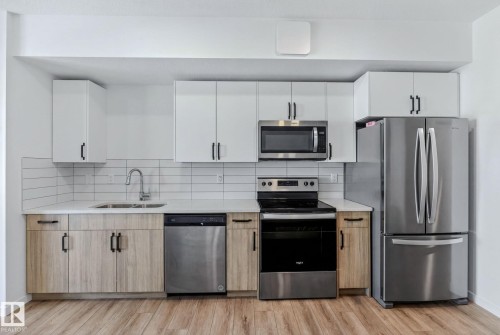 #301 864 Secord Bv Nw, Edmonton, AB - Indoor Photo Showing Kitchen With Stainless Steel Kitchen With Double Sink