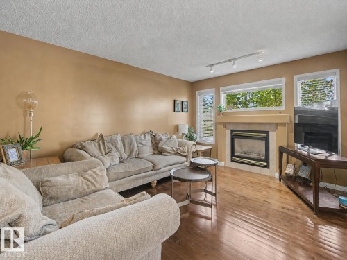 1754 Turvey Bend Bend Nw, Edmonton, AB - Indoor Photo Showing Living Room With Fireplace