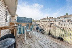 Outdoor wood deck with a privacy fence, featuring a white lattice design - 