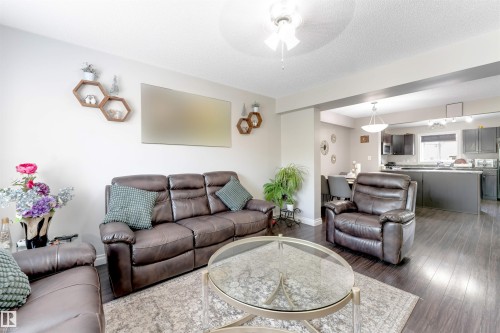 Recessed lighting, wood-finish flooring, and an open layout define this space - 3106 15 Avenue Nw, Edmonton, AB - Indoor Photo Showing Living Room