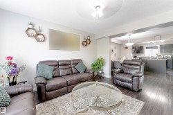 Recessed lighting, wood-finish flooring, and an open layout define this space - 