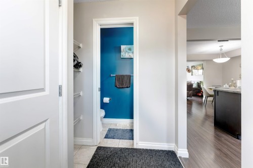 Powder room with vibrant accent wall, ceramic tile flooring, and a towel bar - 3106 15 Avenue Nw, Edmonton, AB - Indoor Photo Showing Other Room