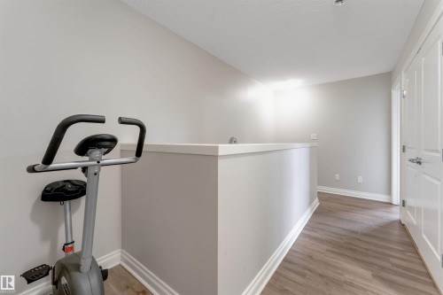 Wood-finish flooring with light gray walls and white trim - 3106 15 Avenue Nw, Edmonton, AB - Indoor Photo Showing Other Room