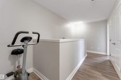 Wood-finish flooring with light gray walls and white trim - 